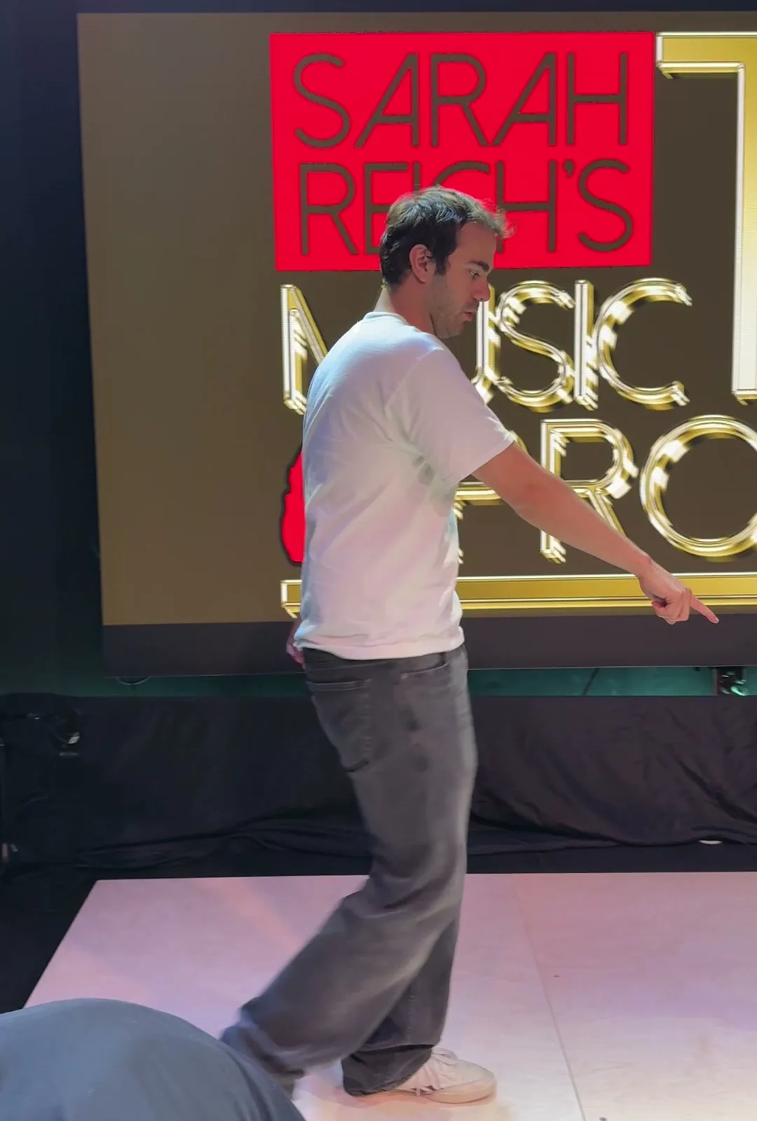 A man tries out the tap floor laid down in the live room, the LED wall lit behind him