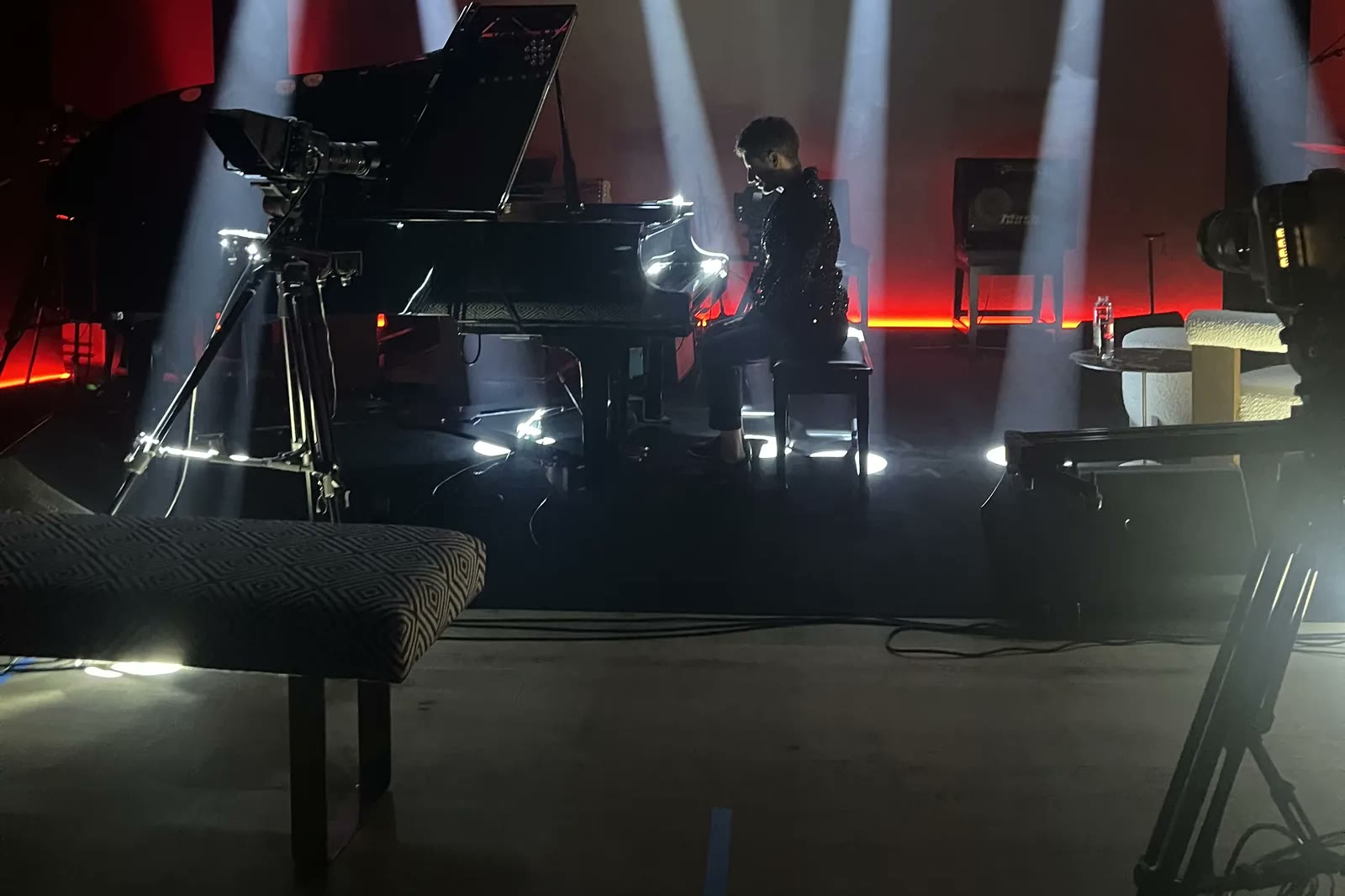 The live room floor under white beams, the grand piano and cameras set